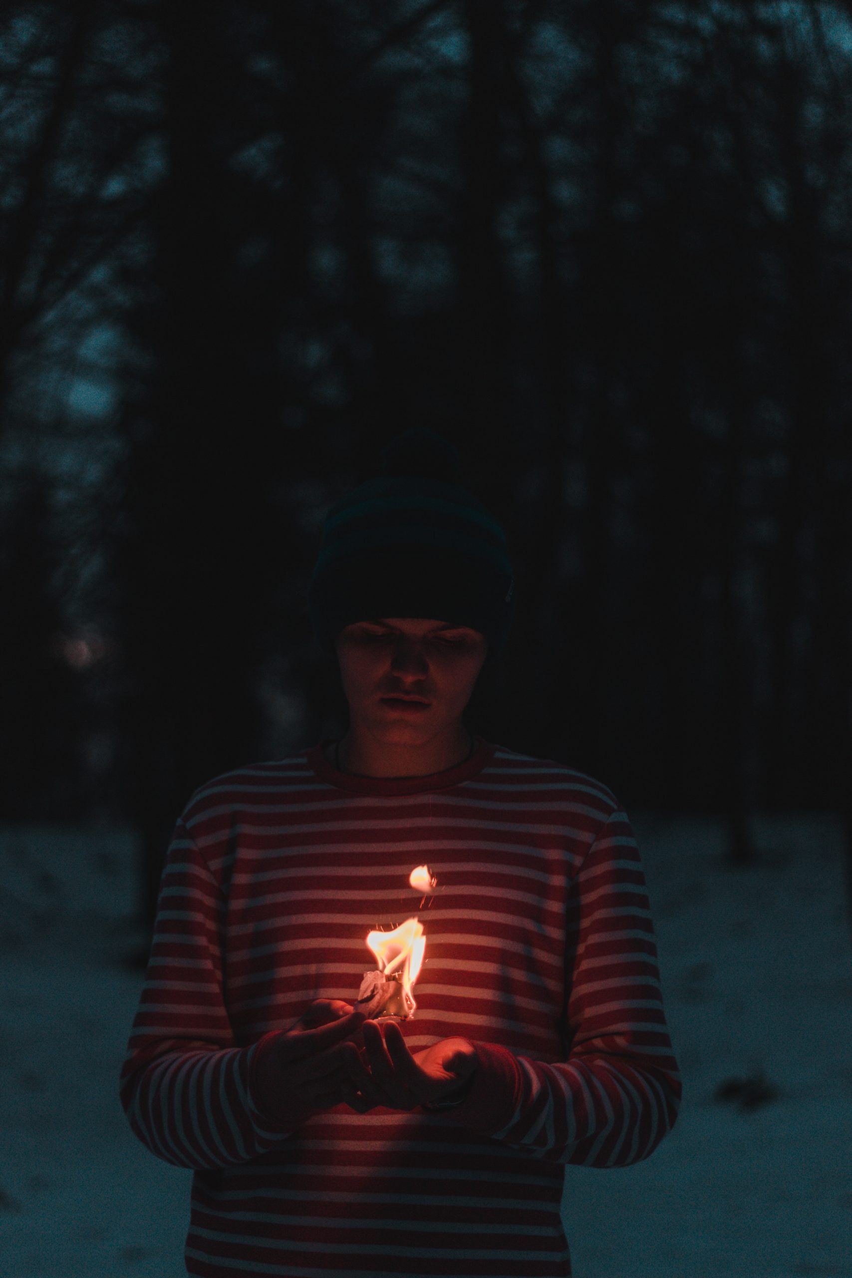 Person holding flame in the snow